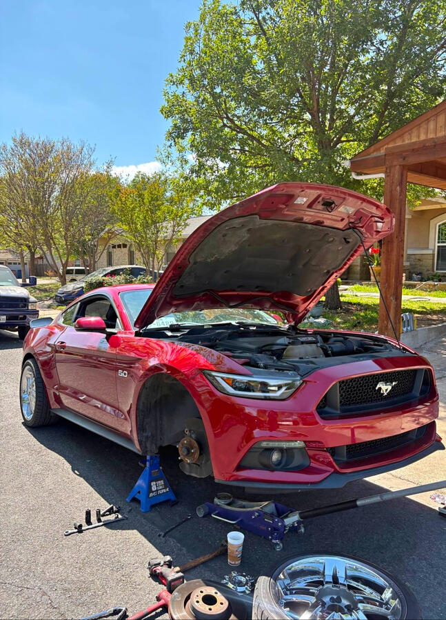 Fort Worth mobile mechanic performing brake repair on Ford Mustang GT at customer home